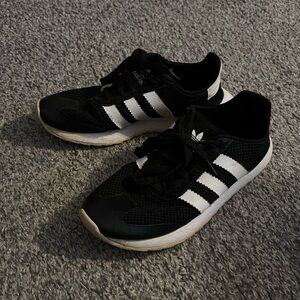 Women’s black and white Adidas sneakers
